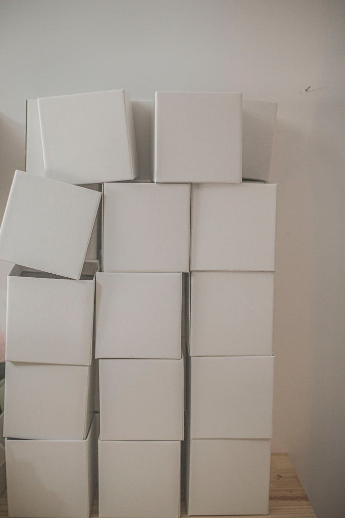 services-04 A vertical stack of plain white cardboard boxes creating a minimalist and simple aesthetic.